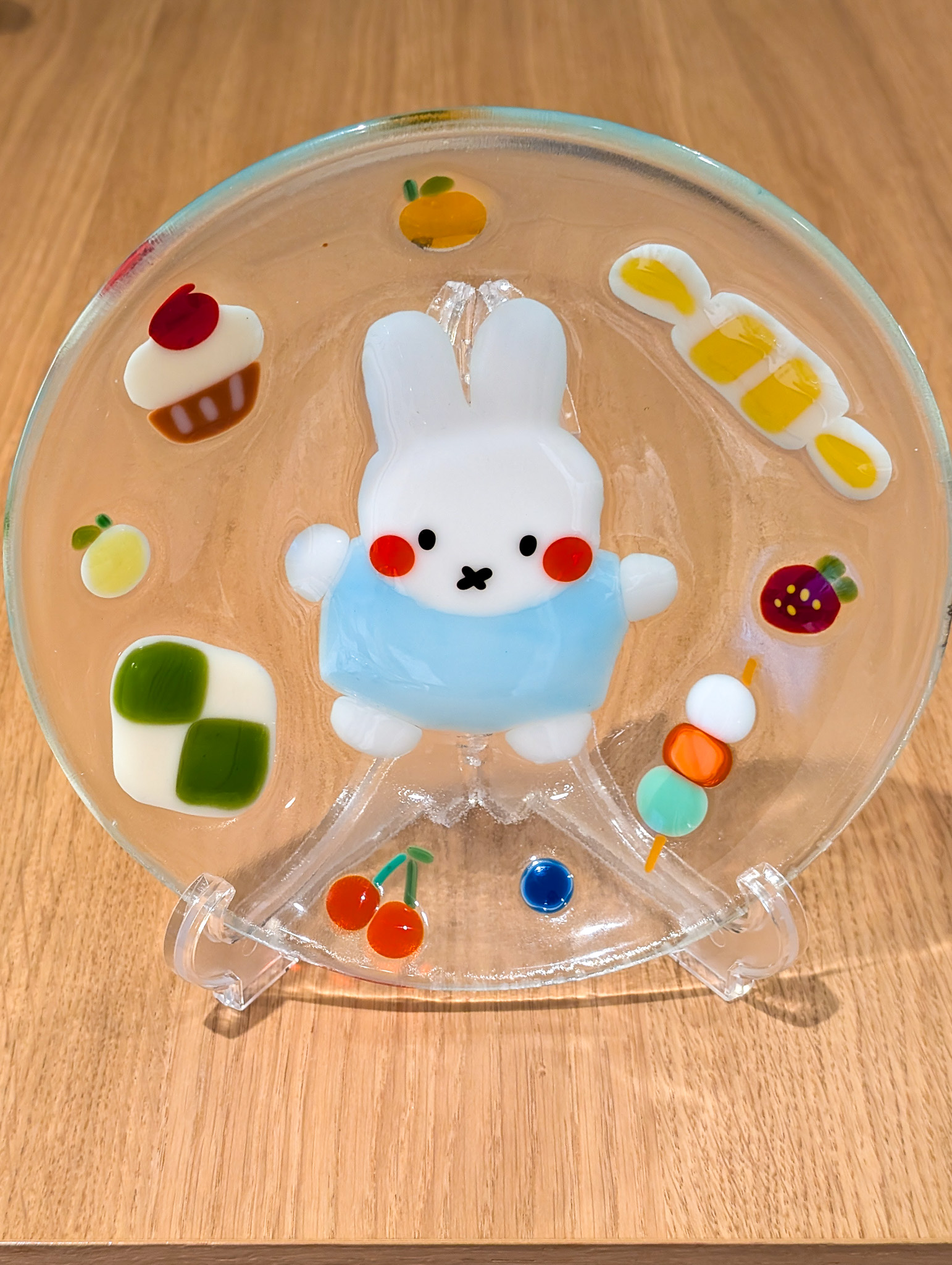 Fused glass bunny dish with fruit and colorful motif details