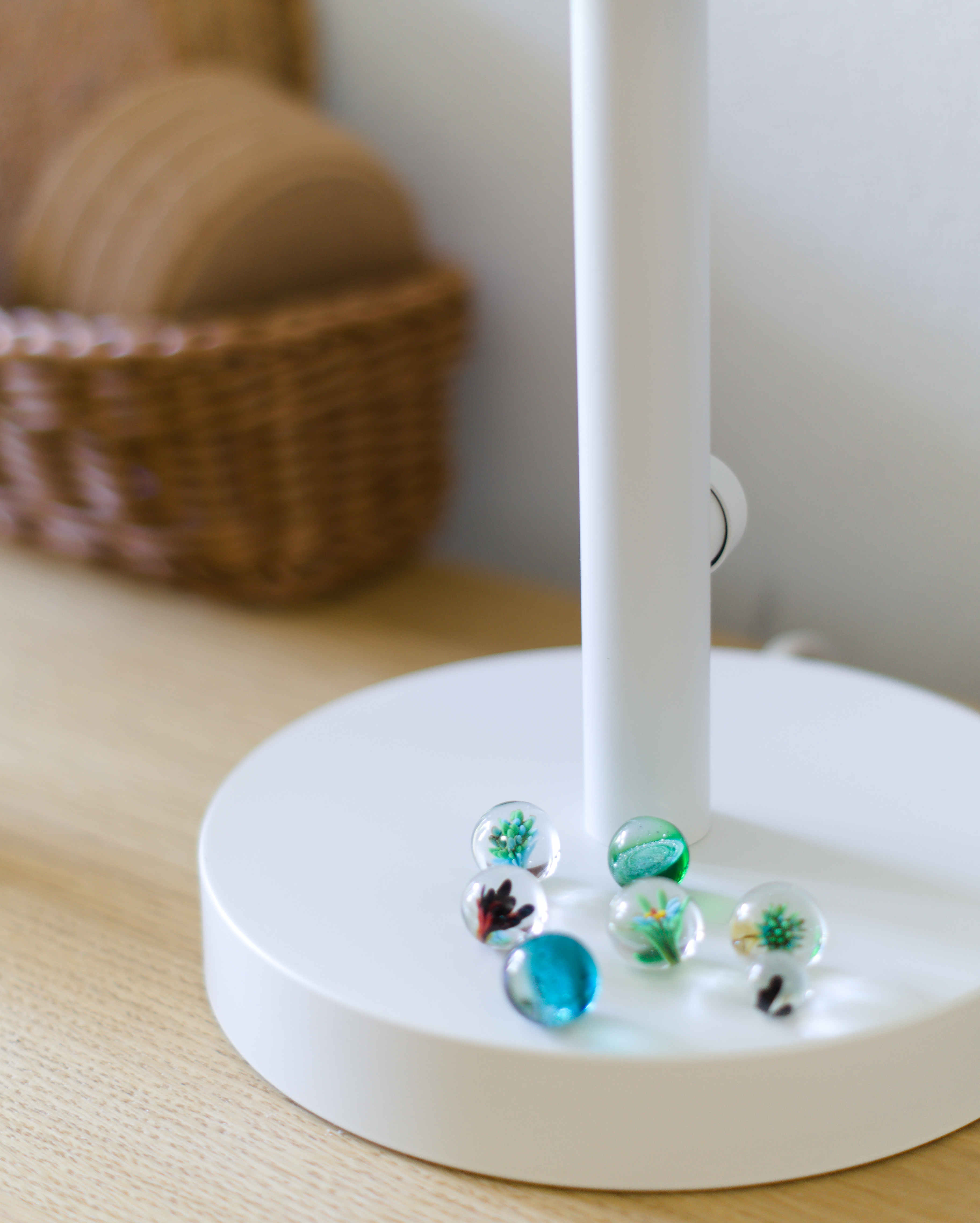 Glass marbles displayed on a white lamp base