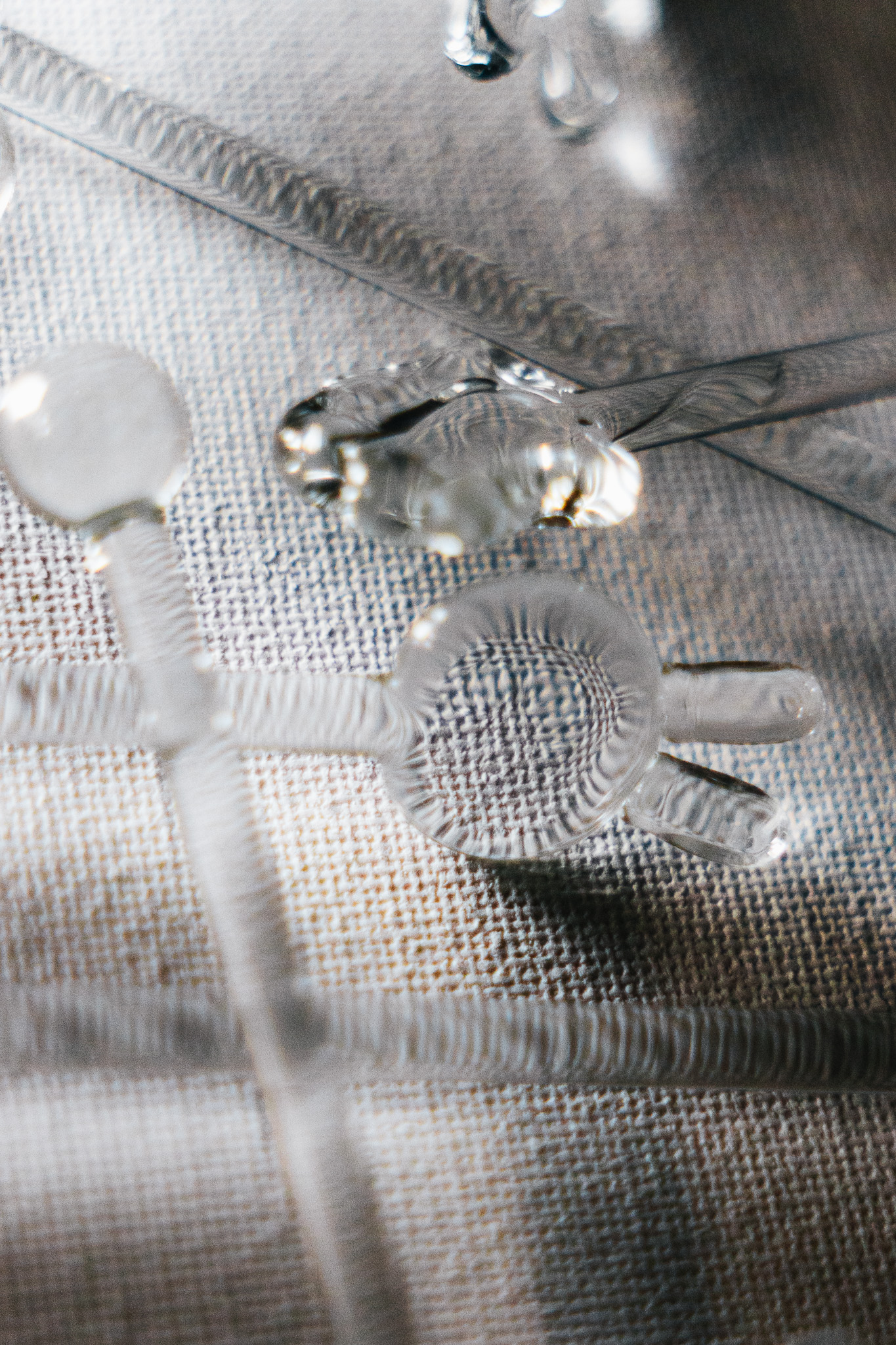 Close view of handmade glass stir rods with sculptural tops